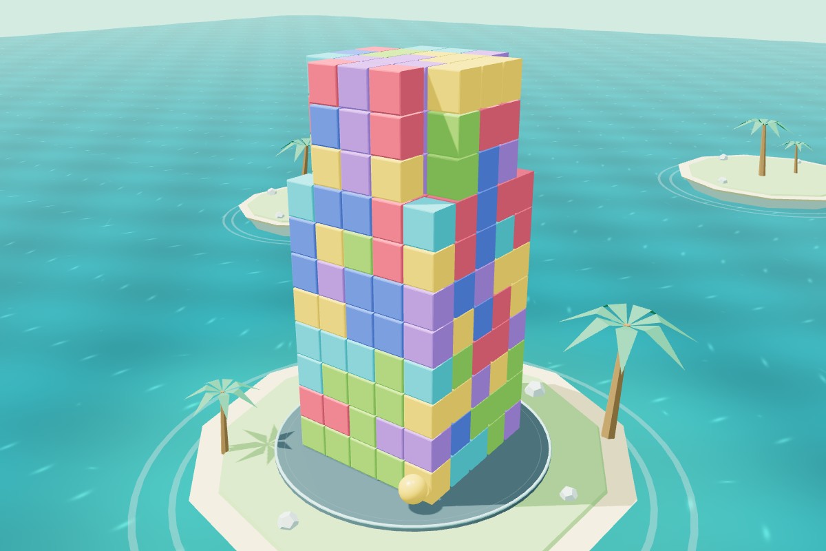 A colorful block tower on a palm-lined island above turquoise water